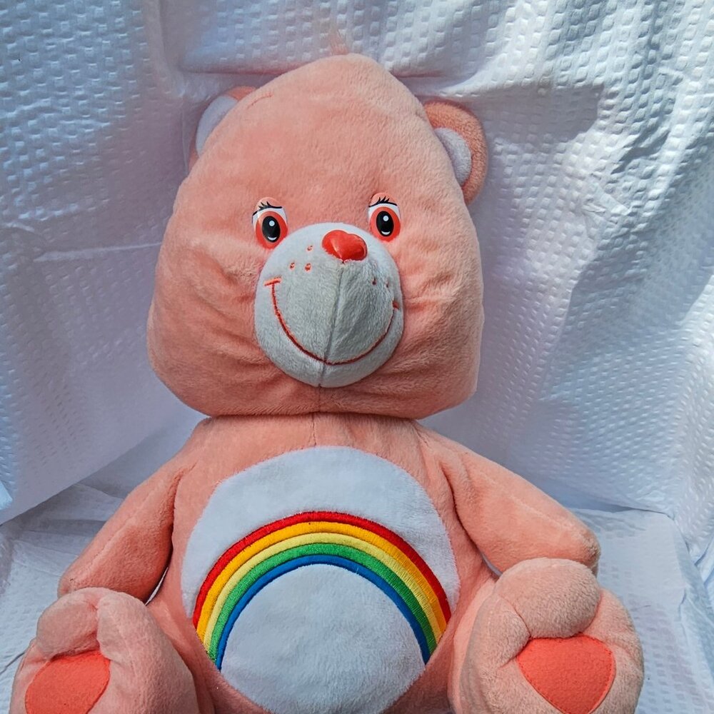 care bear cheer bear with rainbow belly badge dated 2003 NANCO brand peachy pink